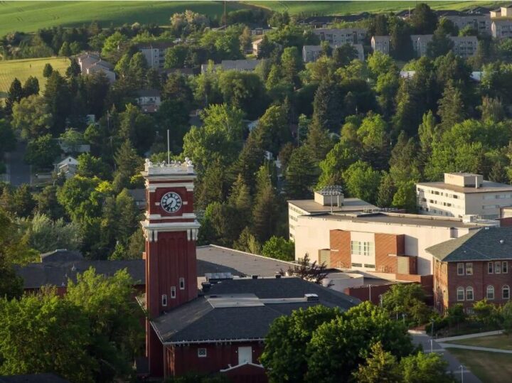 Ariel view of the WSU clock tower surrounded by campus buildings and green trees.