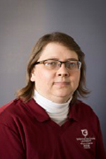 A smiling woman in a WSU shirt.