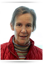 A smiling woman in a red coat.