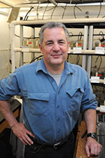 A smiling man in a blue shirt.