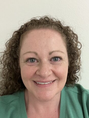 A photo of a woman smiling.