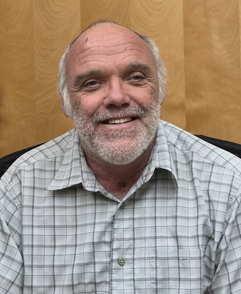 A photo of a man smiling.