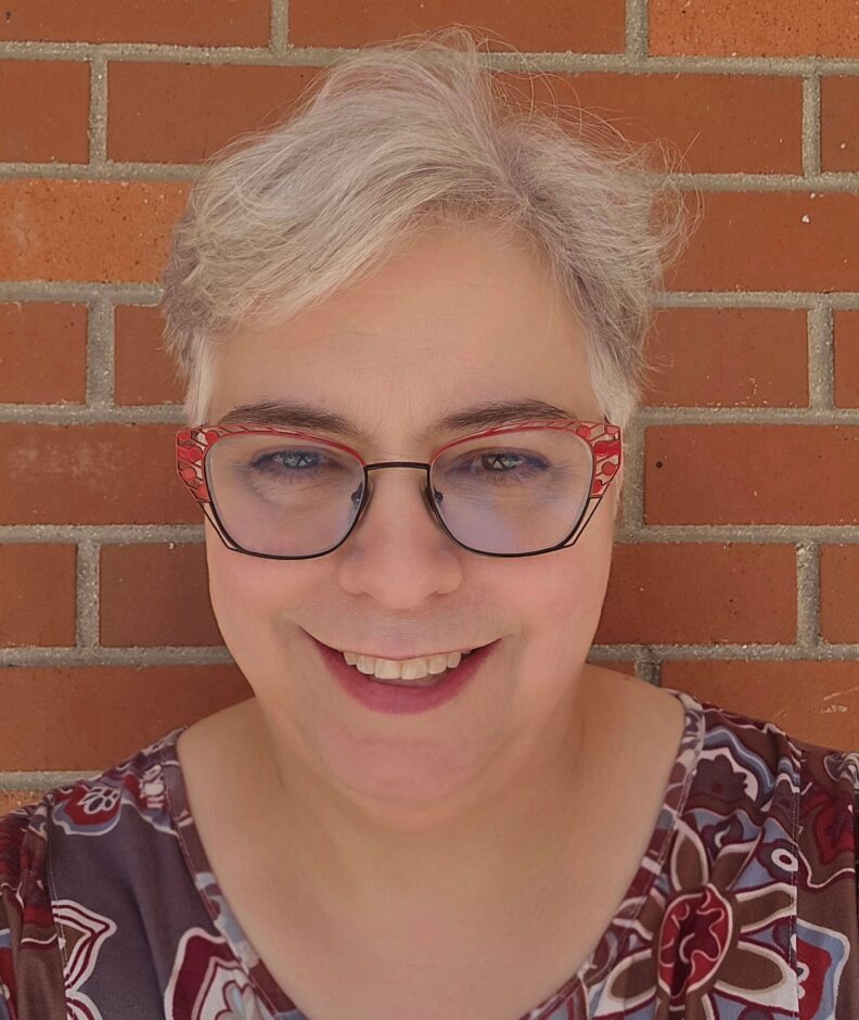 A photo of a woman smiling.