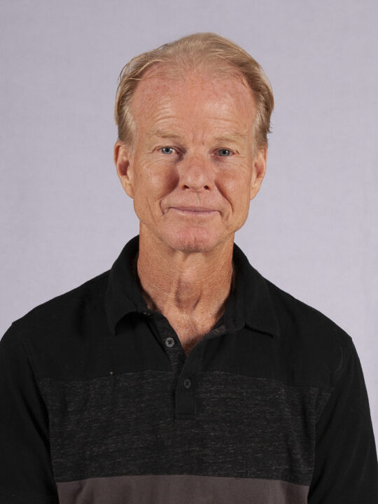 A photo of a man smiling.